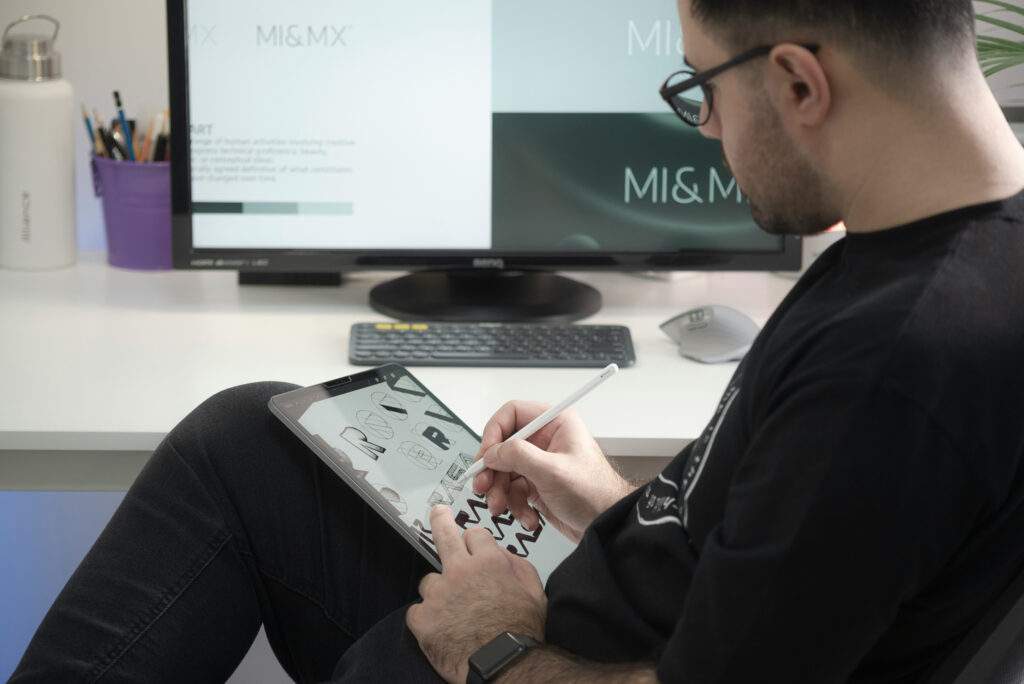 graphic designer sketching logos on an ipad